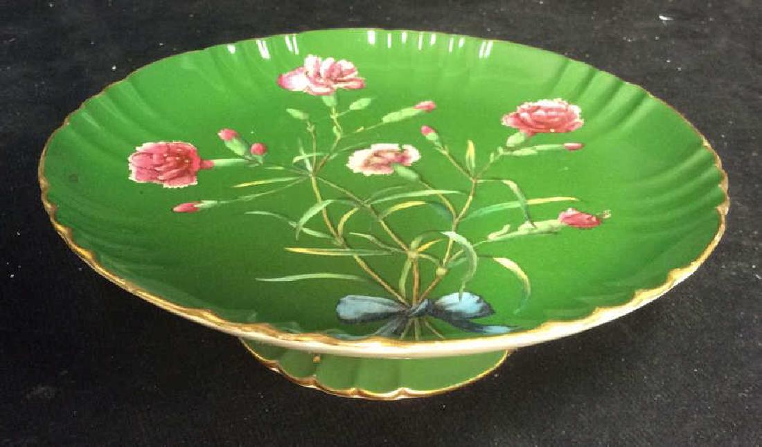Footed Pedestal Porcelain Dessert Server: vintage porcelain green ground with floral detailing, gold rimmed measures ht app 3 inches diameter app 9 inches, has chip at rim