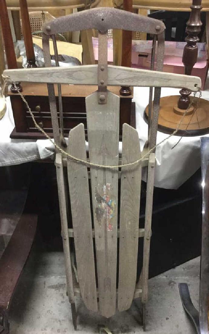 Vintage Flexible Flyer Wood & Metal Sled: Sled still has remnants of Flexible Flyer marking. Contains painted detail. Front of sled has steering rope. Front is slightly loose, needs tightening. Measures approx 48 inches long 22 inches wide, 6