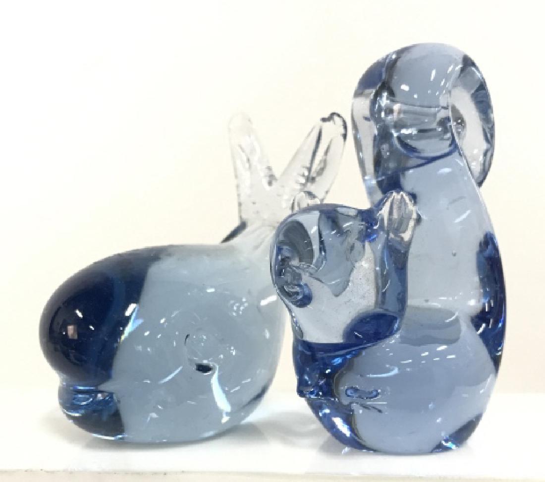 Pair Blue Toned Glass Animal Figurals: Pair Blue Toned Glass Animal Figurals. One squirrel and one whale. Blue toned glass, some surface wear including chips. Tallest piece measures approx 3 1/2 in talk by 2 in long by 1 in wide.