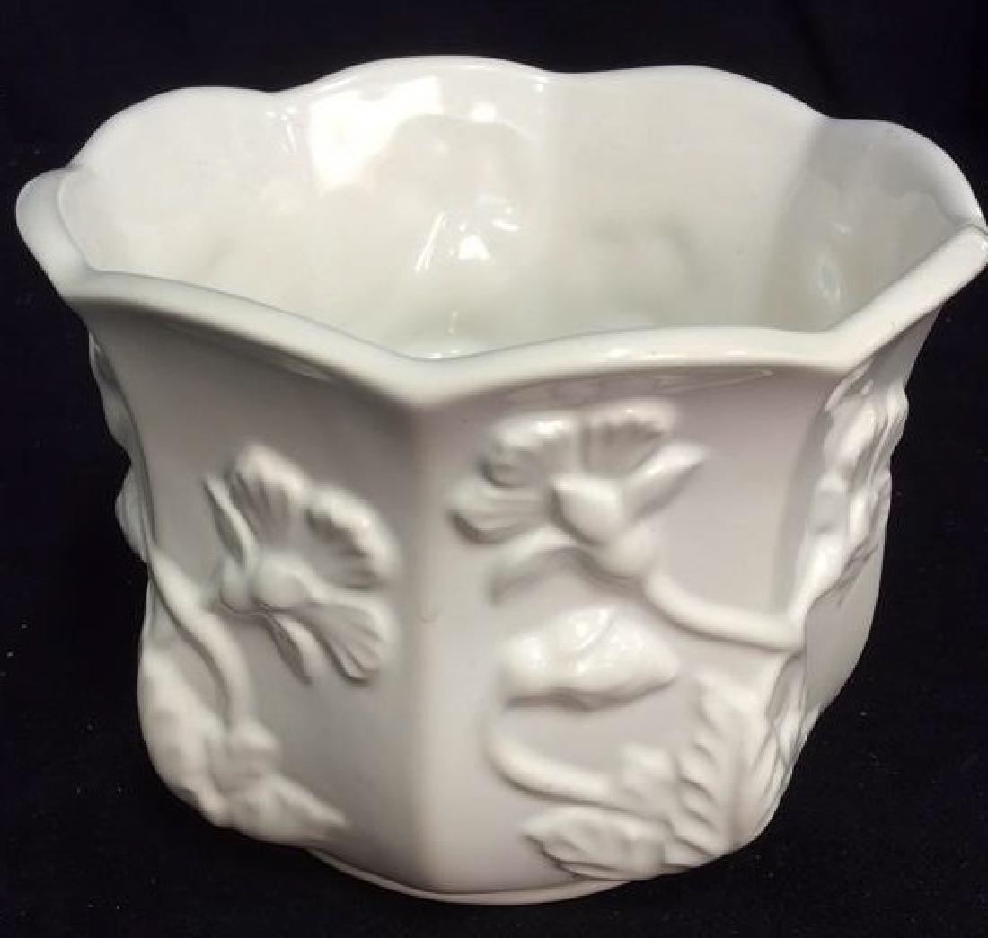 Vintage Portugal Ornate Porcelain Planter: Vintage Portugal ornate porcelain embossed floral white ware planter with flared opening. White, planter, porcelain, embossed, floral. Contains minor chip. Measures approx 5 inches tall x 6.5 inches i