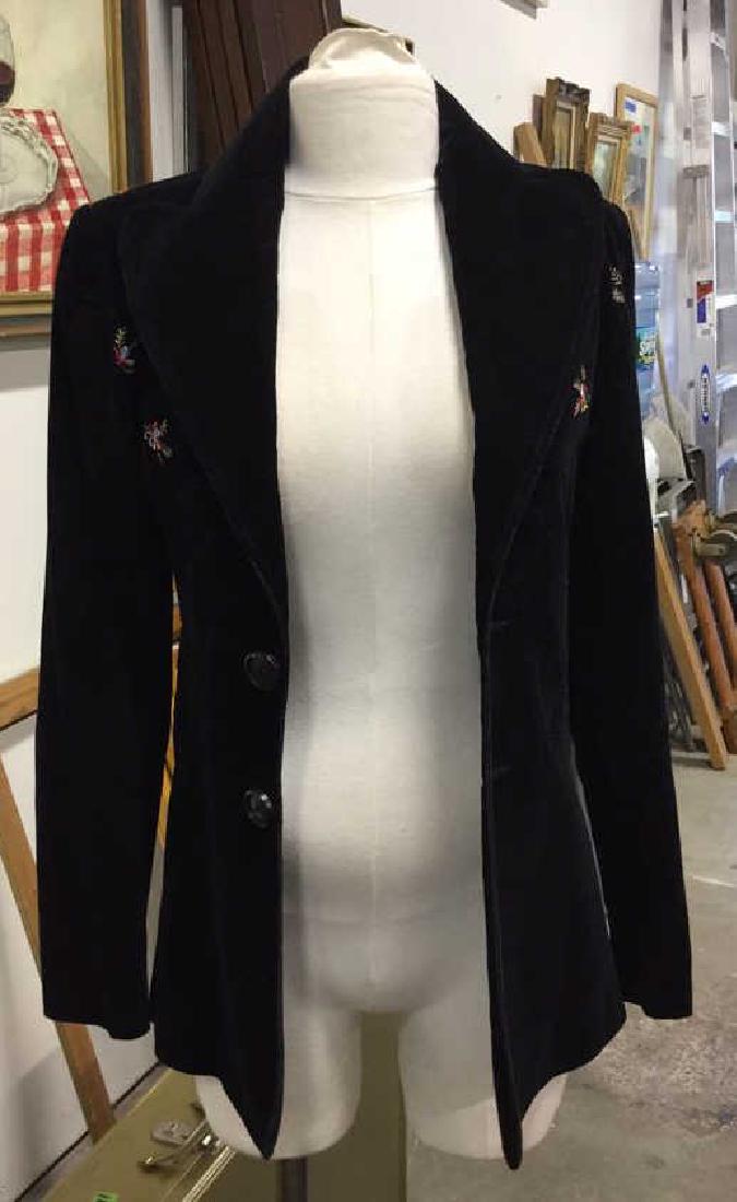 MALCOM BALL Floral Embroidered Blazer: MALCOM BALL floral embroidered blazer. Velvet textured fabric with silk lining. Buttons secure blazer mid-section. Stitching along jacket. Large collar. Measures 16 inches wide, 28 inches long, 24 inc