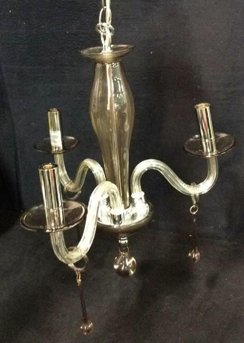 Modern Glass And Chrome Three Armed Chandelier: Modern Glass And Chrome Three Armed Chandelier with hanging hand blown teardrop drops. Modern home decor. Modern Lighting. Very minor surface scratches. Measures approx 18 inches tall x 16 inches wide