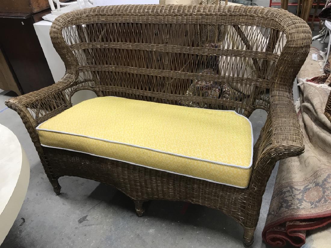 Woven Wicker Loveseat W Cushion: Loveseat is woven wicker. Includes yellow toned cushion. Wicker loveseat is light brown toned. Measures approx 58 inches long 38 inches tall, 31 inches deep. Wicker has some breaks in weaving. Love se