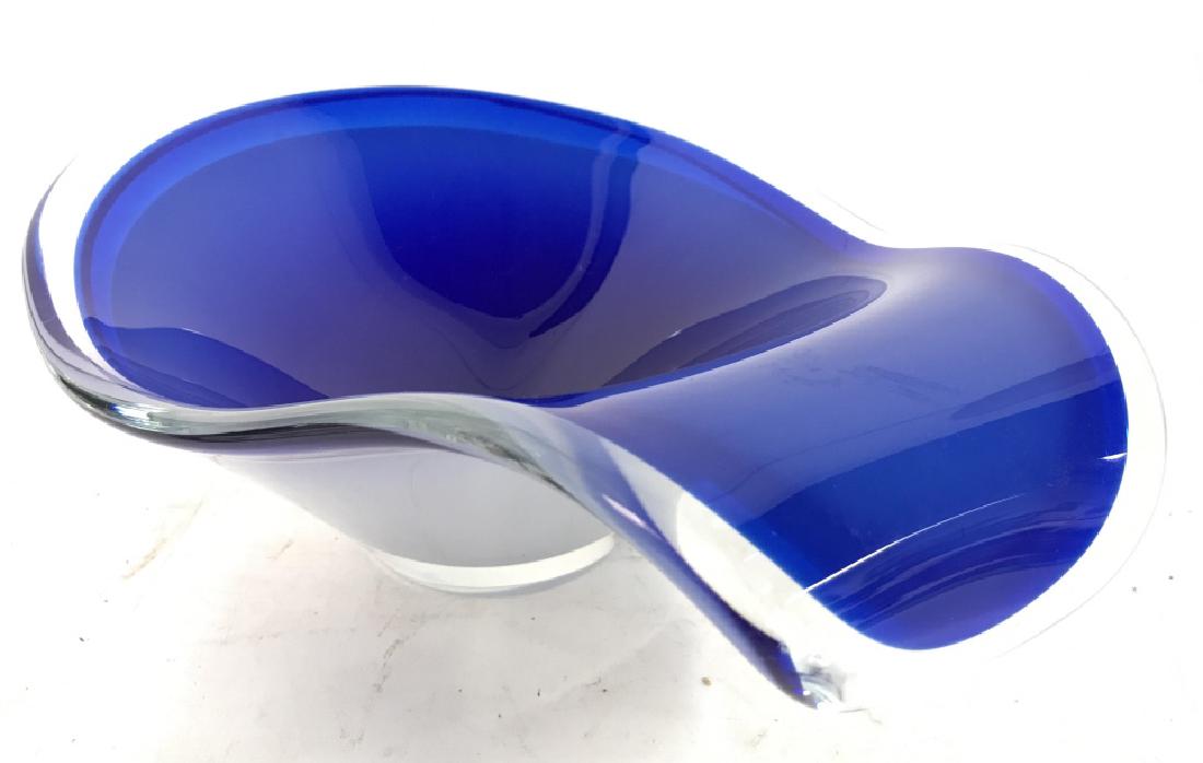 FLYGSFORS Signed Art Glass Bowl: Art glass is blue toned on inner area and white toned on outer area. Contains small signature on underside. Measures approx 16 inches long, 6 inches tall, 11 inches wide. Art glass, centerpiece, glass