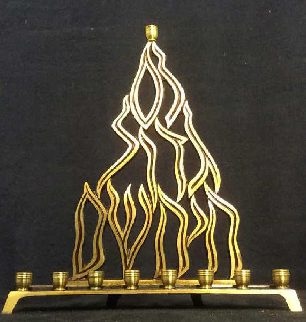 Gold Toned Metal Judaica Menorah: Menorah is gold and maroon toned. Underside reads KL1161 ISRAEL. Center candle holder is on top. Measures approx 9.5 inches tall 8 inches wide. Judaica, menorah, gold toned menorah, metal menorah. Jew