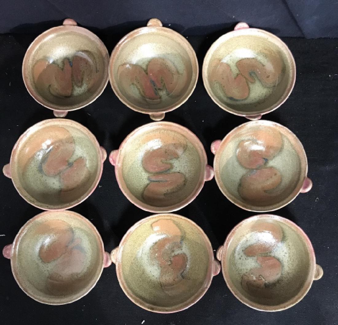 Group Lot Ceramic Bowls Signed N.Price: Group lot. Bowls are ceramic green and red tones. Each bowl has two tabs on each side for lifting. Each bowl has two swirl patterns on the inside. Measures 7 inches wide, 3 inches tall.