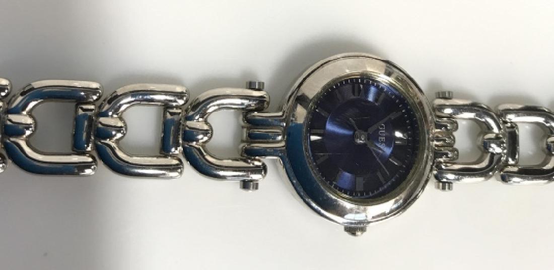 GUESS Silver Toned Metal Ladies Wristwatch: GUESS Silver Toned Metal Ladies Wristwatch. Silver toned body and link band with blue toned face. Women's fashion accessory. Measures approx 7 in king when laid flat. Some minor surface wear and scrat
