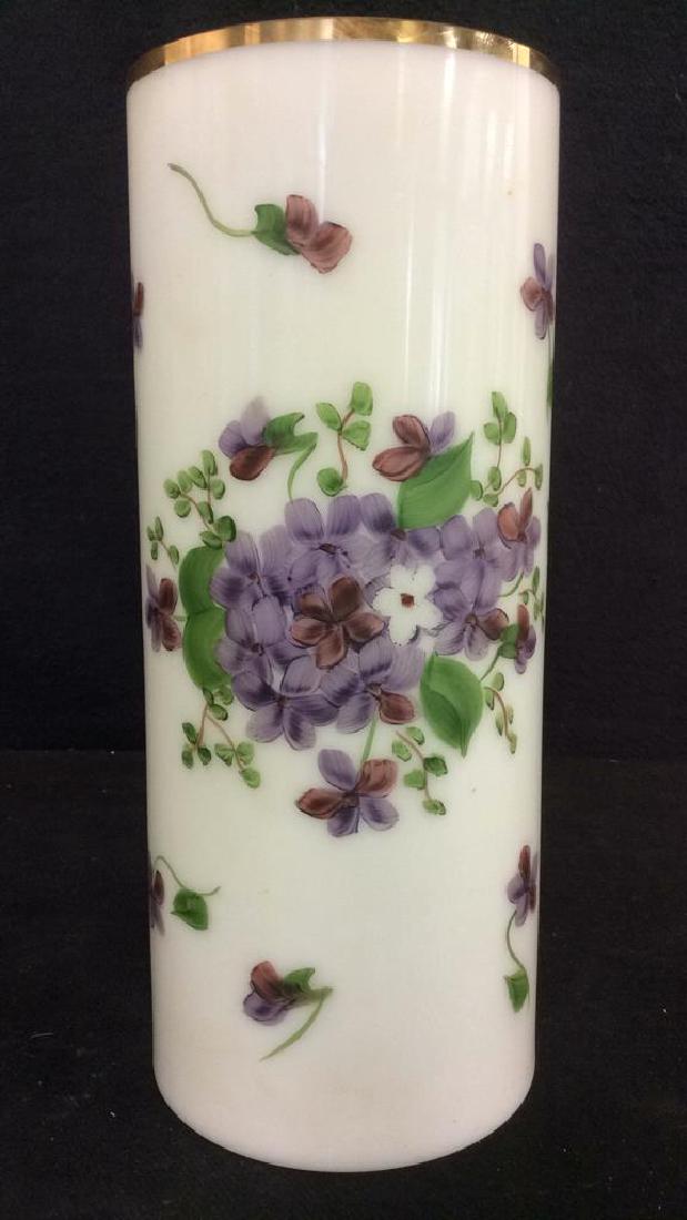 Hand Painted Consolidated Glass Vase: Piece has gold toned rim. Vase is hand painted with tones of purple & green with floral and vine detail. Tag on underside reads CONSOLIDATED GLASS. Has some wear on rim. Contains negative space white