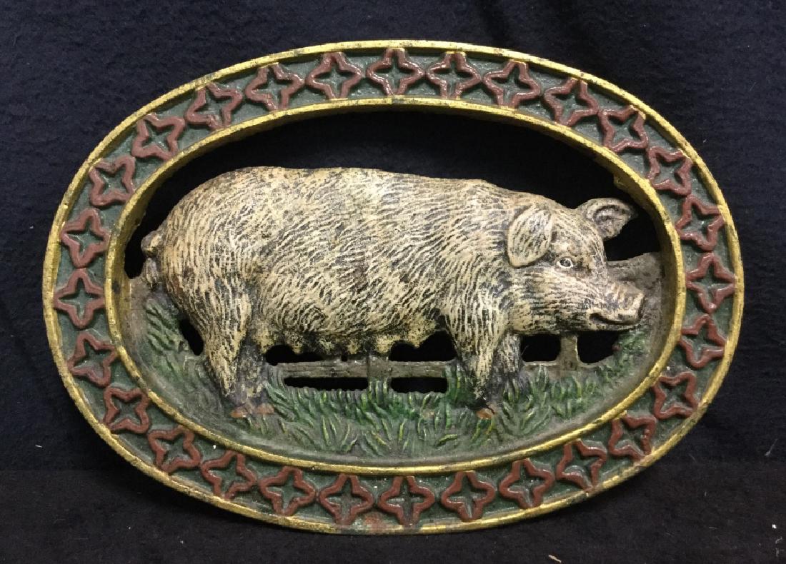 Painted Pig iron Metal Trivet: Trivet is possibly steel. Cut out pig and fence design. Trivet is painted gold, red, white and green toned. trivet has four “feet”. Measures approx. 9inches by 5.5 inches.