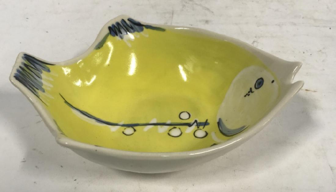 Ceramic Yellow Toned Fish Formed Bowl: Ceramic fish bowl contains yellow toned design with blue and white detail. Bottom reads 1986 Animals & Co. no. 791 GS 9189. Measures approx 2 inches tall x 7.5 inches long x 6.5 inches wide.