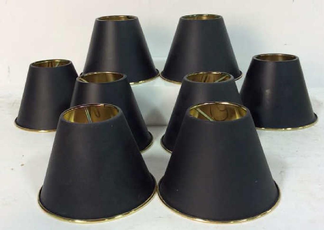 Lot 8 Metal Lampshades for Chandelier: Lot 8 Metal Lampshades for Chandelier. Group of 8 metal lampshades, gold toned metal interior pitch black toned painted metal exterior. Some minor surface wear. Measures approx 4 in tall by 5 1/2 in i