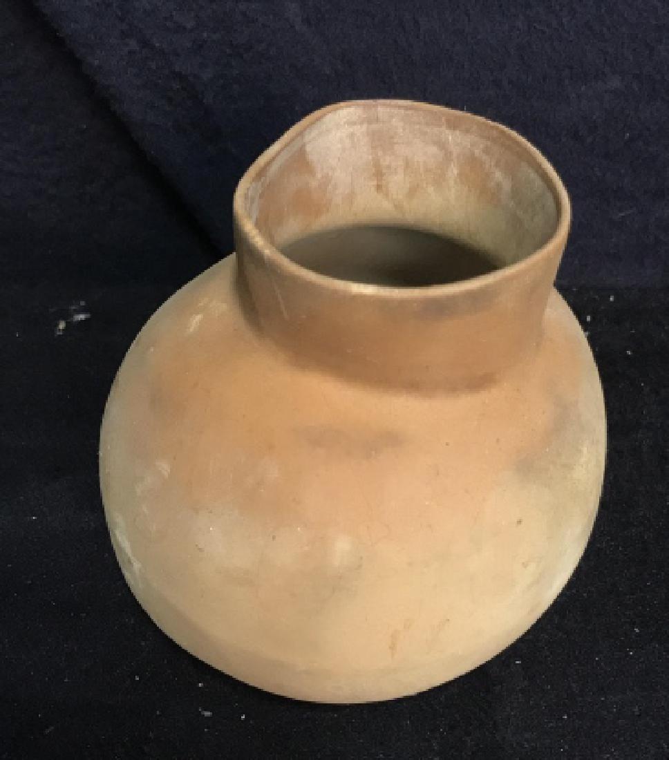Brown Multi-Toned Leather Vessel: Brown toned leather pot or bowl. Bowl is possibly leather. Measures 4 inches by 5 inches wide. Table accessories, leather accessories, leather pot. Vessel, vase, decorative table top accessory