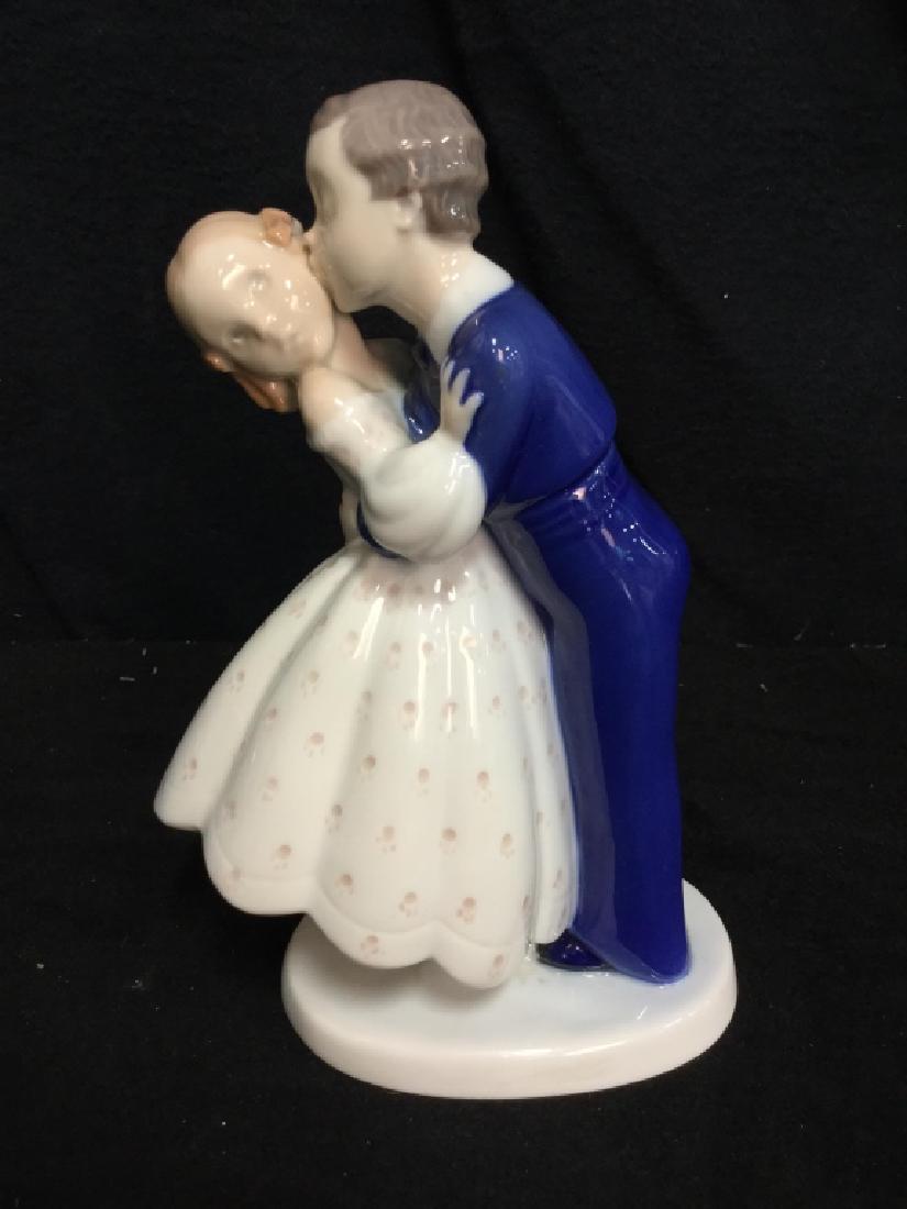 Porcelain Girl and Boy Kissing Figural: Ceramic girl and boy. Girl in dress and Boy in suit. Boy is kissing girl on the cheek in a romantic pose. Table top accessories, ceramic sculptures , porcelain figurlas, numbered and trademarked under
