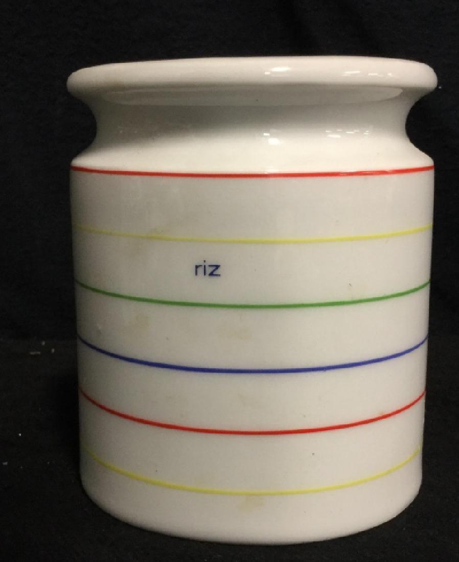 Porcelain Rainbow Striped Vase Made in Spain: Vase is white toned Porcelain. Vase has Rainbow toned stripes, stripes are red, yellow, green, and blue toned. HERRAMADI porcelain, made in spain. Measures 5.5 inches tall, 4.5 inches wide.