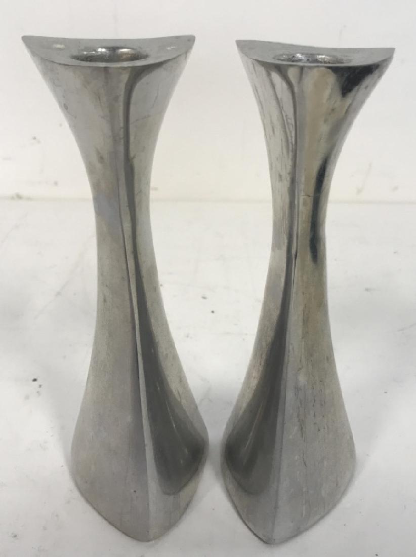 Pair Nambe Vintage Candle Sticks: Mod form sinuous lines pair of candle sticks, circa 1980’s, marked underside for NAMBE 595, pewter toned