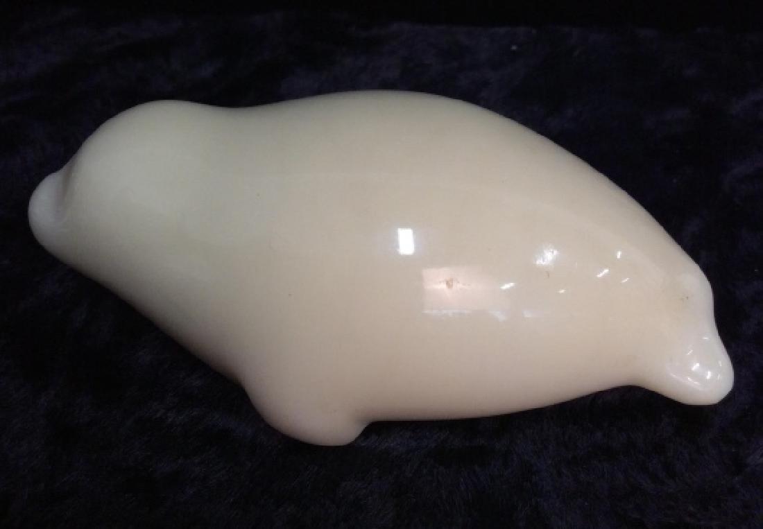 Carved Signed Sculpted Sea Figural: Carved Signed Sculpted Sea Figural. Minimalist streamlined carving of a seal, possibly bone. Signed on underside as Perry. Measures approx 2 in tall by 3 1/2 in long by 1 1/2 in wide.