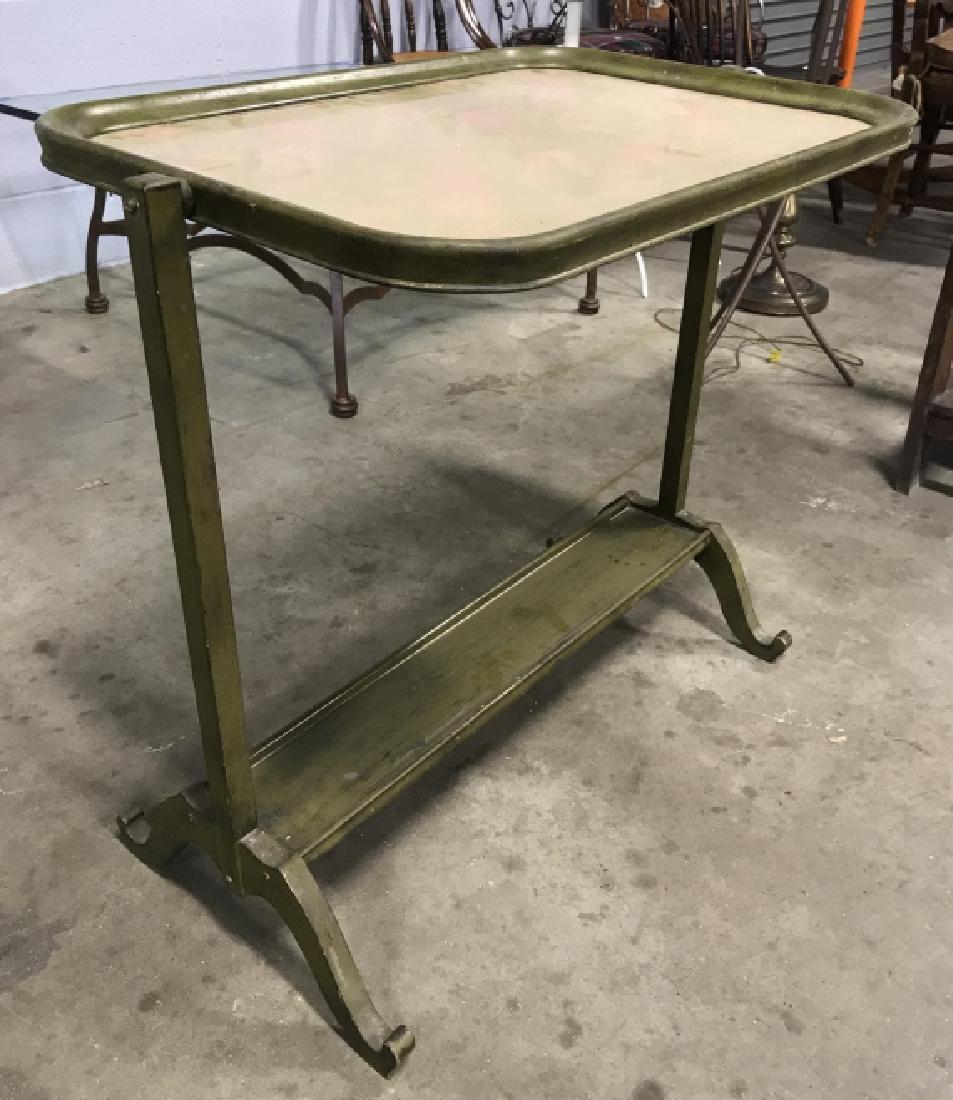Floral Detailed Rotatable Tray Table: Vintage possibly antique, Table is wooden. Contains an olive green tone. Tabletop contains pink toned floral detail. Measures approx 27 inches tall 28 inches long, 18 inches deep. appears to be vintag