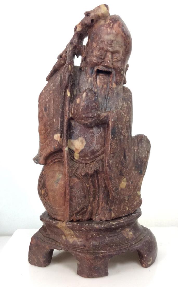 Vintage/Antique Chinese Soapstone Elder Man: Vintage/Antique Chinese Soapstone Elder Man in Robes Carved Statuette. Brown toned soapstone itch black and beige toned natural coloration, smiling elder man in robes. Set on carved soapstone base of
