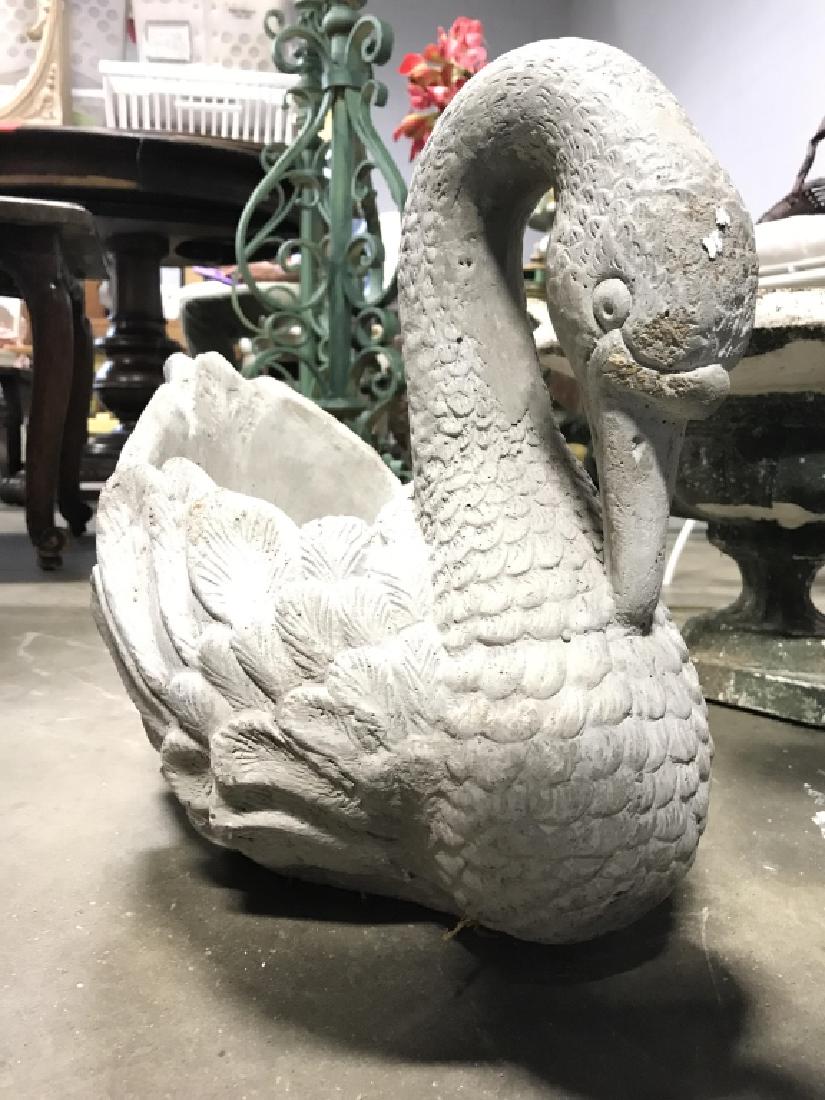 Cement Swan Lawn Ornament Planter: Lawn ornament has shape resembling a swan. Contains space in center for plant. Piece is grey toned. Come minor weathering and minor chips. measures approx 14 inches tall and deep 10 inches wide.