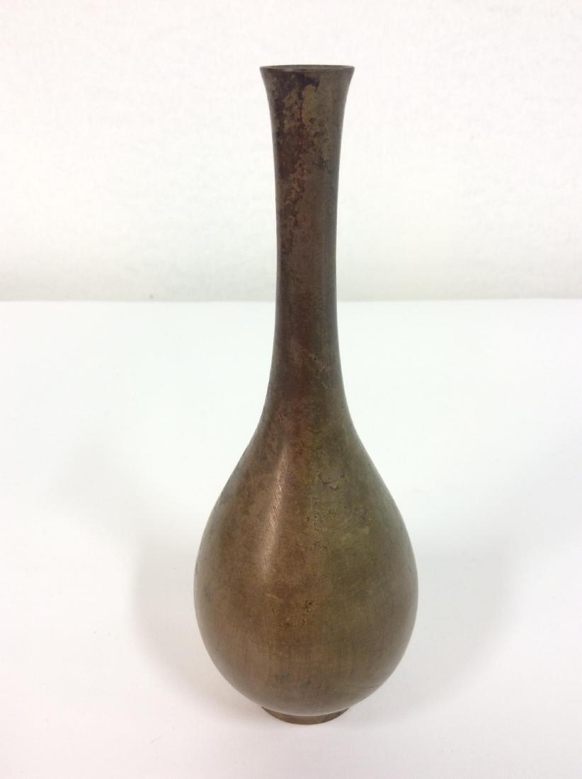TOYO Japanese Metal Bud Vase: TOYO Japanese Metal Bud Vase. Vintage tall neck Japanese metal bud vase in bronze color. Some minor discoloring. Measures approx 7min tall by 2 1/2 in in diameter.