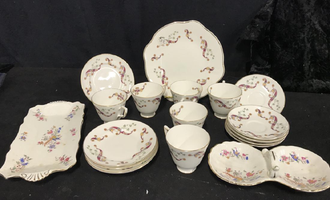 ROYAL TARA China Set Made in Galaway: ROYAL TARA , Fine bone china set, made in Galaway, bottom reads "Clonmacnoise" Set is white and gold toned with green, blue, red, orange accents. Set contains 5 plates that measure 6 inches, 6 cups me