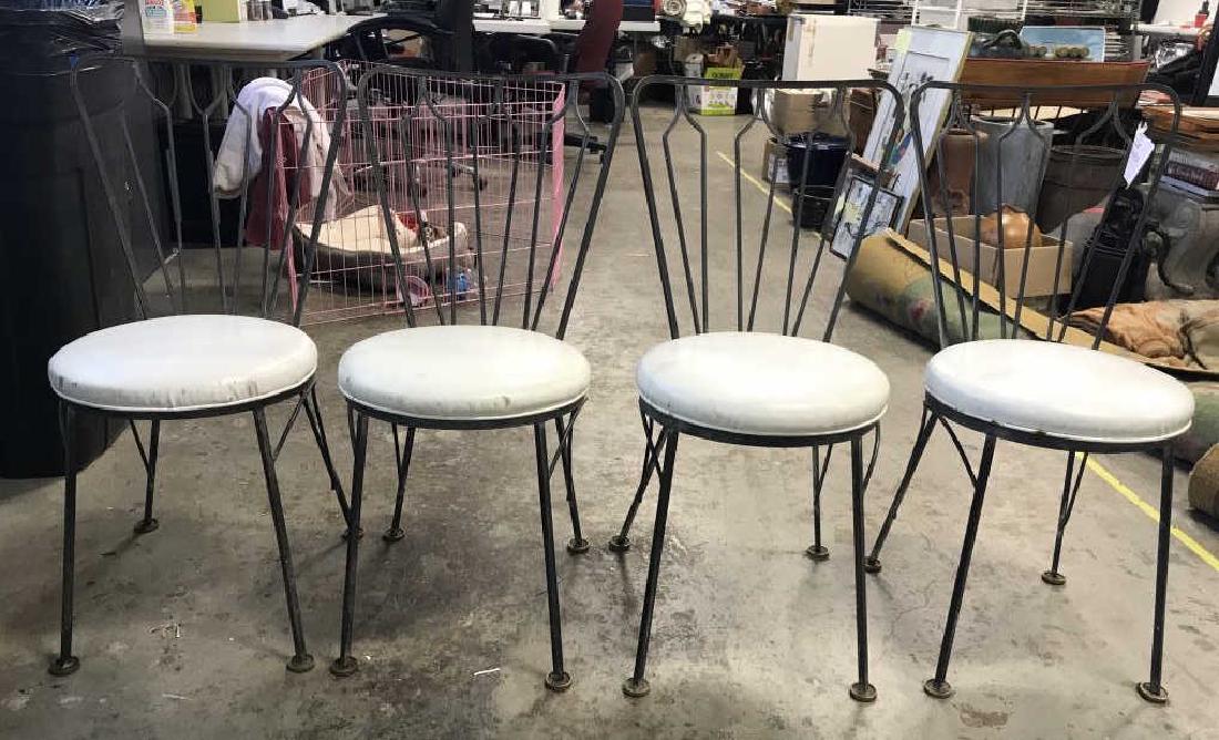 Set 4 Retro Metal Chairs W Leather Seats: Vintage Chairs appear to possible be rod iron. EAch chair has cream toned circular leather seats. Each measures approx 33 inches tall 20 inches deep 25 inches wide. VIntage kitchen chairs, dining chai