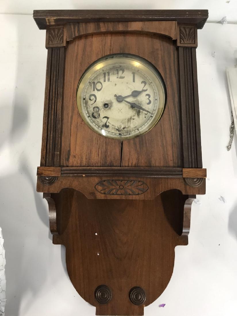 Vintage BORNE Carved Wooden German Clock: Vintage BORNE Carved Wooden German Clock. Some pieces need repair has some cracks. measures approx 25 inches tall 13 inches wide 5 inches deep. Contains evident surface wear. Tag appears to read in Ge