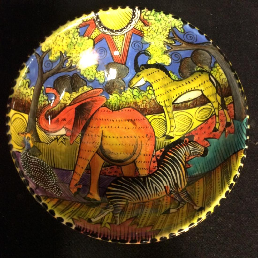 Hand Made And Painted In Zimbabwe Penzo Bowl: Hand made and painted in Zimbabwe ceramic bowl by Sanelisiwi Mpofu for Penzo 2009. Bowl is multicolored including blue, yellow, orange, green, etc. Painting depicts an elephant, a zebra, and an antelo