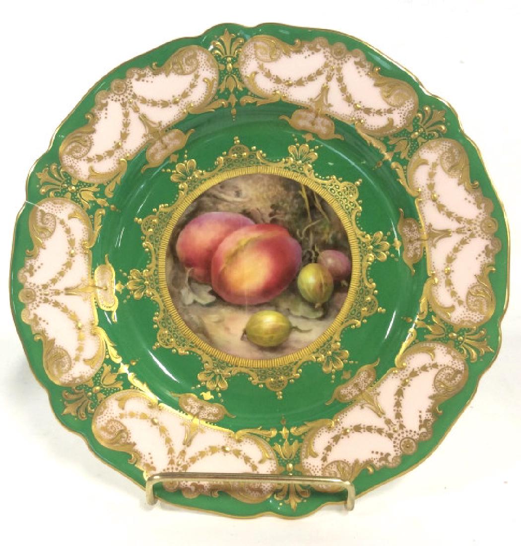 ROYAL WORCESTER English Porcelain Plate: ROYAL WORCESTER English Porcelain Plate. Green and pink toned body with gilt style gold toned decorative filigree design with center fruit design. This piece has been broken and repaired, shelf piece.