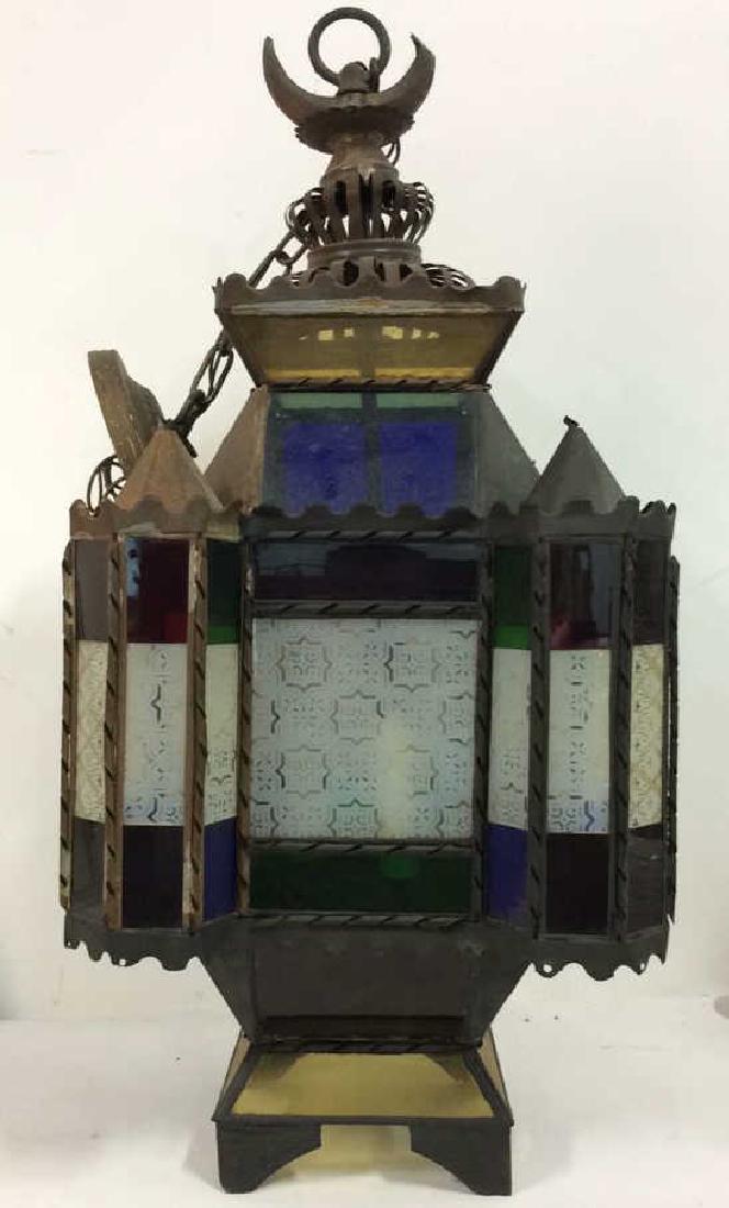 Stained Glass Ornate Architecture Inspired Light: Fixture Stained Glass Ornate Architecture Inspired Light Fixture. Black toned metal with panels of stained and patterned glass in jewel tones including red, blue and green, Some surface wear including