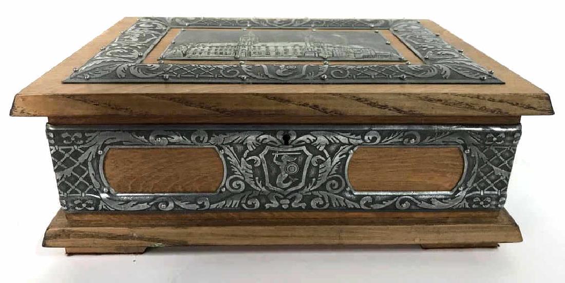 W STOSIO Oak & Silver Toned Decorated Poland Box: Underside of box reads SPOTAZ RZEMIESLNICZA ZOLIBORZ ZAKRAD RZEMIESLNICZY W. STOSIO WARSZAWA MURMANSKA 29. Box has intricate silver toned vine, leaf, detail and more. Box comes with key. Interior has 