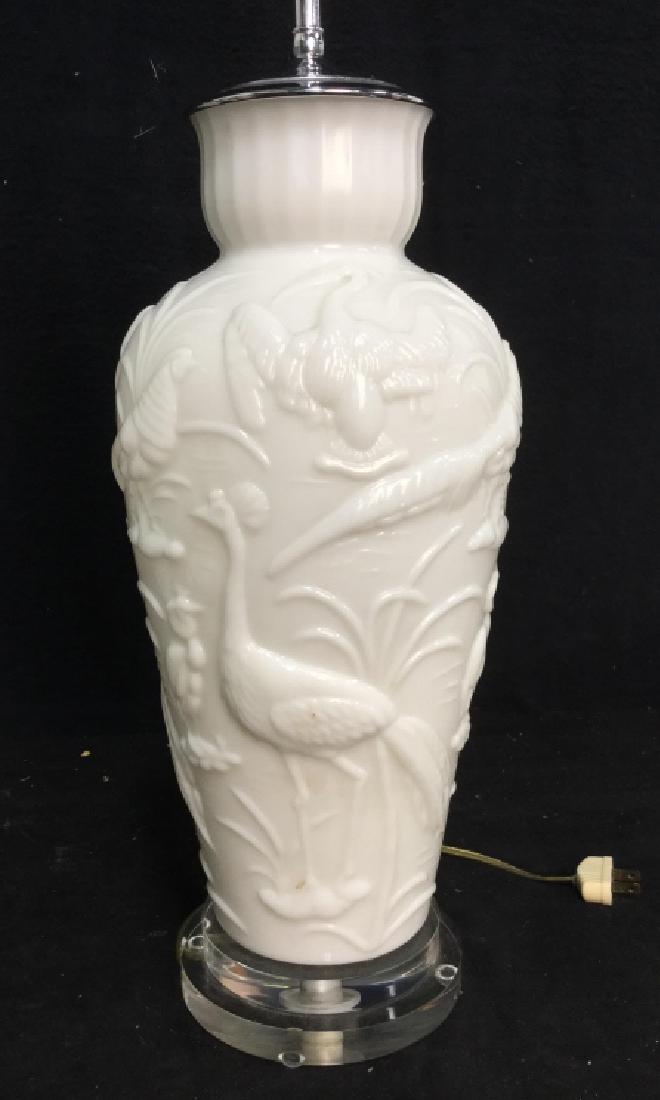 White Glass Bird Relief Lamp: White glass lamp on lucite circular base features various birds in Relief flamingos, storks, pheasants and marsh reeds, double light, good condition measures app 30 inches to finial, possibly vase tur