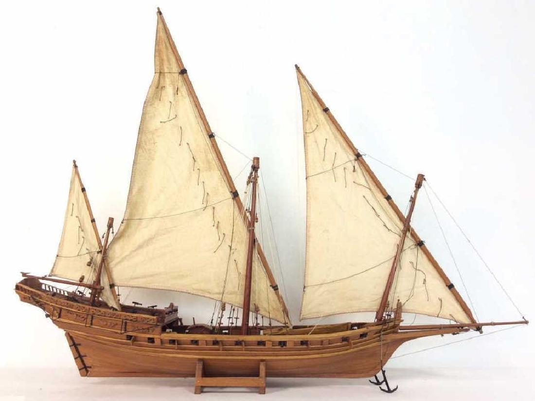 Large Ships Model Nautical Home Decor: Ships Model Nautical Home Decor. Ship with three triangular sails and canons, warship Model, on small wooden base. Light toned wood body, tan toned fabric sails. Some surface wear, pieces that need to