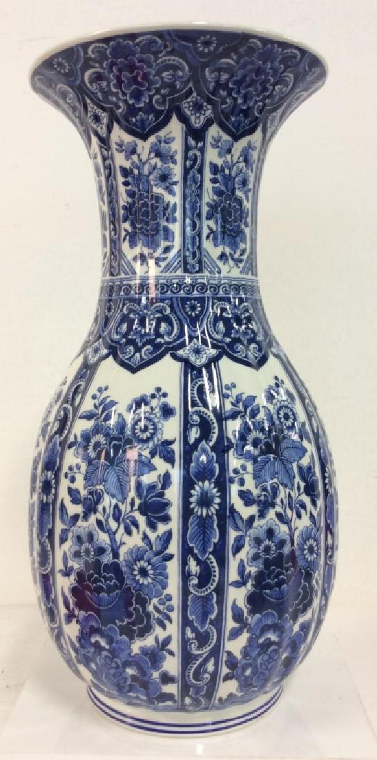 Porcelain Blue and White Floral Vase: Porcelain Blue and White Floral Vase. White toned porcelain vase with blue toned floral design. Some minor surface wear. Measures approx 14 in tall by 7 in wide. Porcelain, china, Tabletop Accessories
