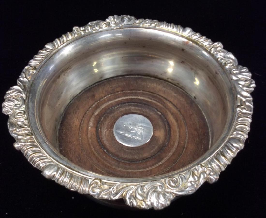 Silver Plated Victorian Wine Bottle Coaster: Silver Plated Victorian Wine Bottle Coaster. Silver plate on copper Victorian wine bottle coaster rounded sides and a decorated rim with filigree design. Is designed with a wooden base with original b