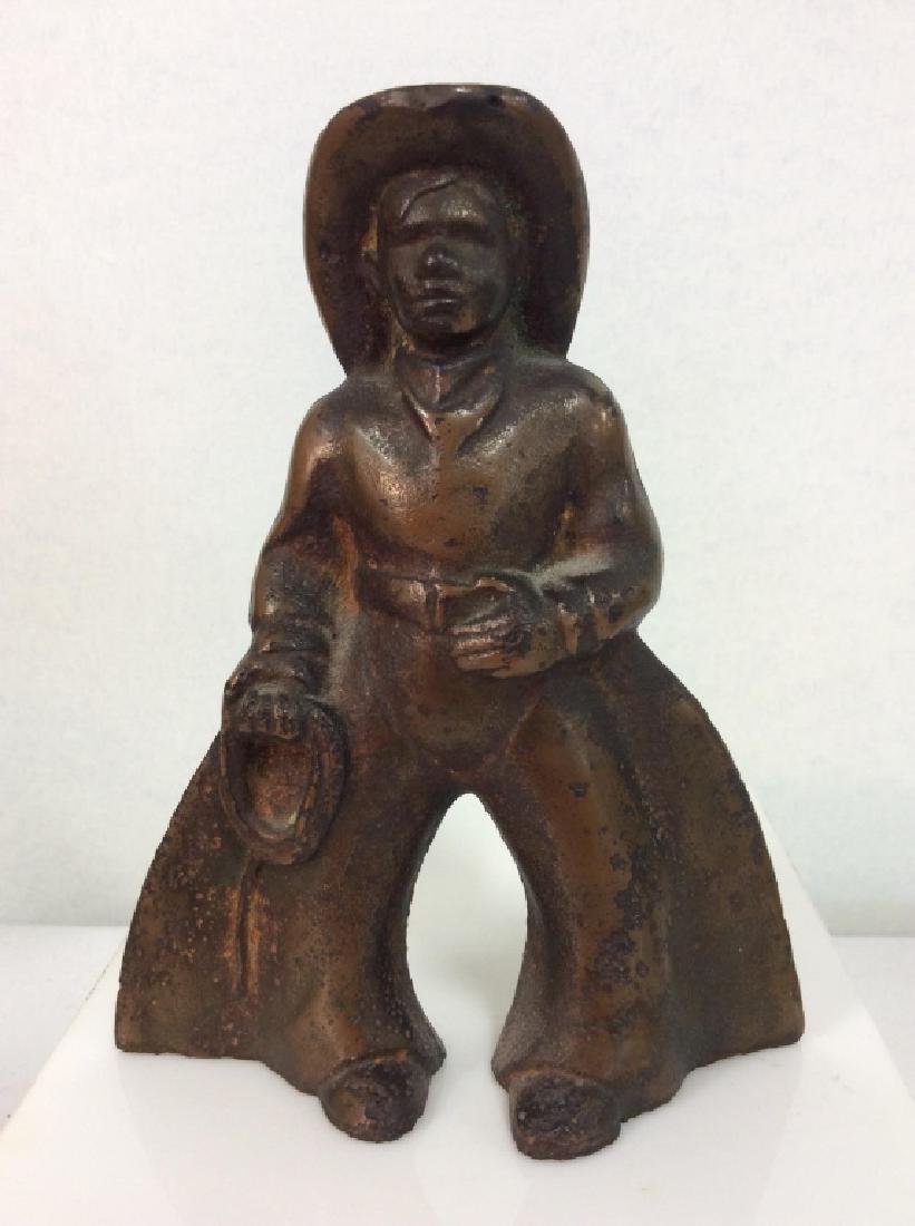 Cast Iron Cowboy Figural Doorstop: Cast Iron Cowboy Doorstop. Cowboy figural doorstop, cast iron with weathered brown toned finish. Some minor surface wear. Measures approx 6 in tall by 5 in long by 2 in wide. Western Decor, Collectibl