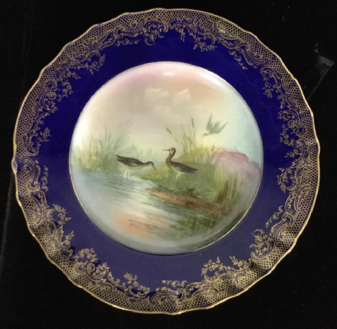 Vintage Haviland France Porcelain Duck Plate: Hand painted porcelain plate with gold accents, deep blue, and marsh birds in marsh setting, marked underside for Theo Haviland , Limoges France, Higgins and Seiter New York,, measures diameter app 9 