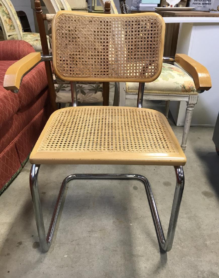 Marcel Breuer Style Chair W Caning: Chair has wooden armrests, appears to have chrome frame. Seat and backrest have caning. Measures approx 31 inches tall 24 inches wide 21 inches deep. Piece is in good condition. Vintage, midcentury in