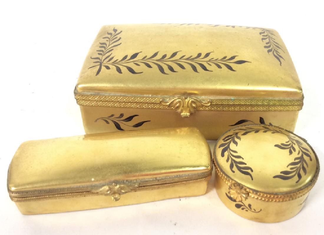 Set3 LIMOGES Gilt Keepsake Boxes: Set3 LIMOGES Gilt Keepsake Boxes. Gold toned hand painted porcelain boxes with black toned leaf vine motif. Largest measures approx 2 in tall by 5 1/2 in long by 4 in wide. Pillboxes, Trinket Dishes, 