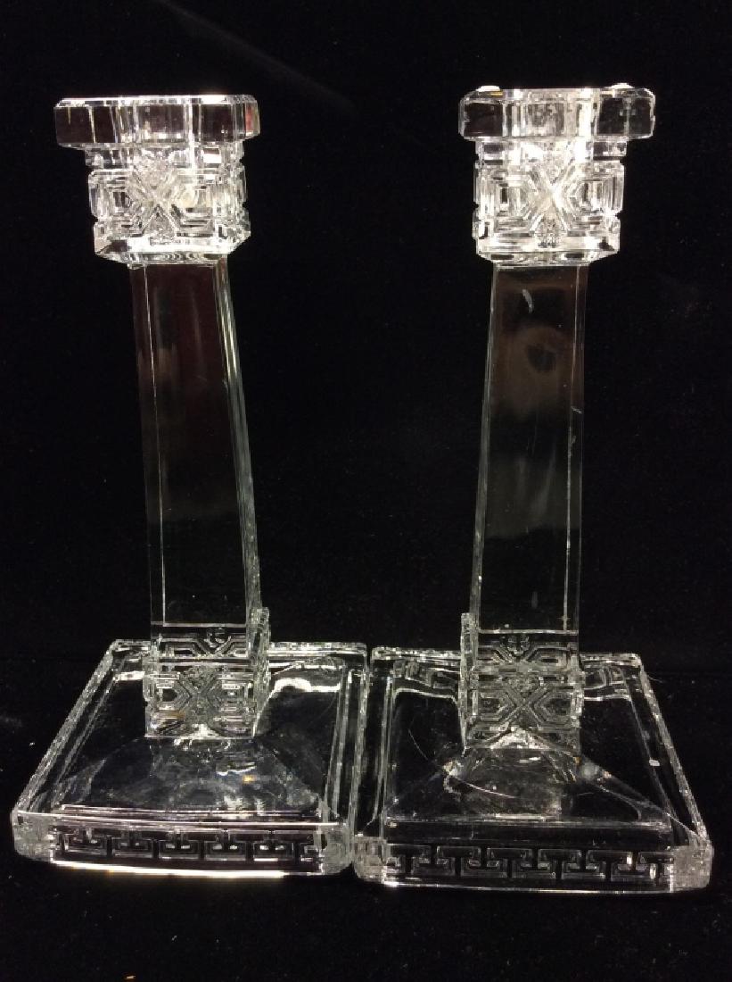 Antique Pressed Glass Candlesticks: Antique Pressed Glass Candlesticks. Clear pressed glass, geometric line design and floral motif details. Some minor surface wear and very minor chips. Measures approx 8 in tall by 4 in by 4 in.