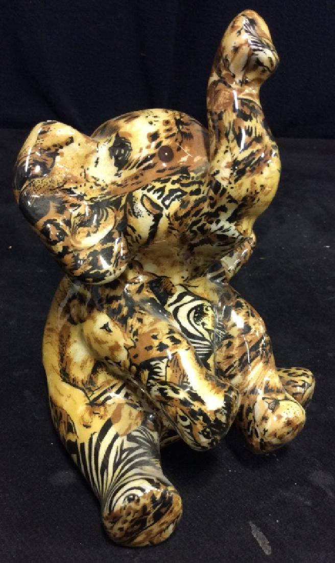 Ceramic Seated Elephant: In animal print colors, good condition, measures ht app 8 inches. Tabletop accessory, animal figural.