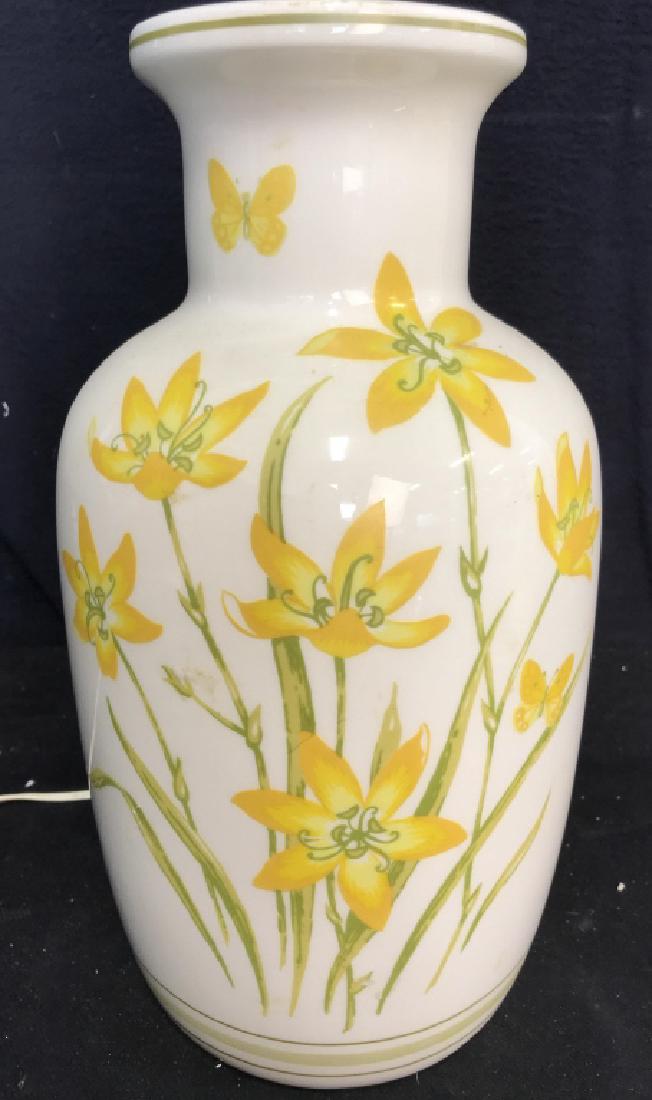 Cream Toned Floral Detailed Porcelain Lamp: Lamp has yellow and green toned floral detail. Lamp does not include shade but includes finial. Measures approx 28.5 inches tall 8 inches wide. Table lamp, floral lamp, home accessory.