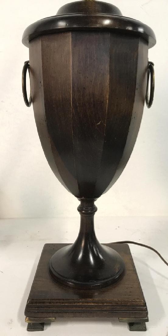 Carved Wooden Trophy Shaped Lamp: Lamp has pedestaled trophy like shape with gold toned dangling loop detail. Lamp does not include shade but includes gold toned finial. Only contains minor wear. Measures approx 29 inches tall 6.5 inc