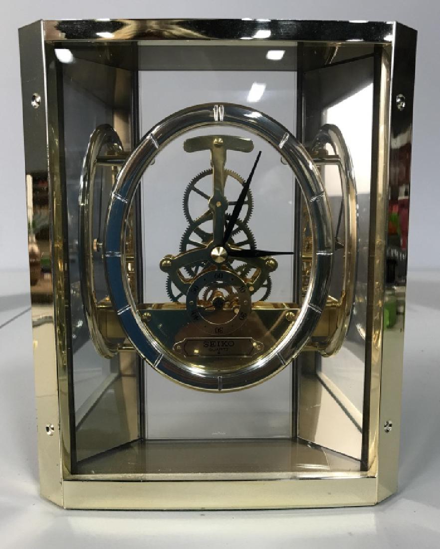 SEIKO Brass Toned Transparent Desk Clock: Good condition, marked for SEIKO, measures app 8 by 6 inches, plastic siding, Luxury home decor, home accesssory, table clock.
