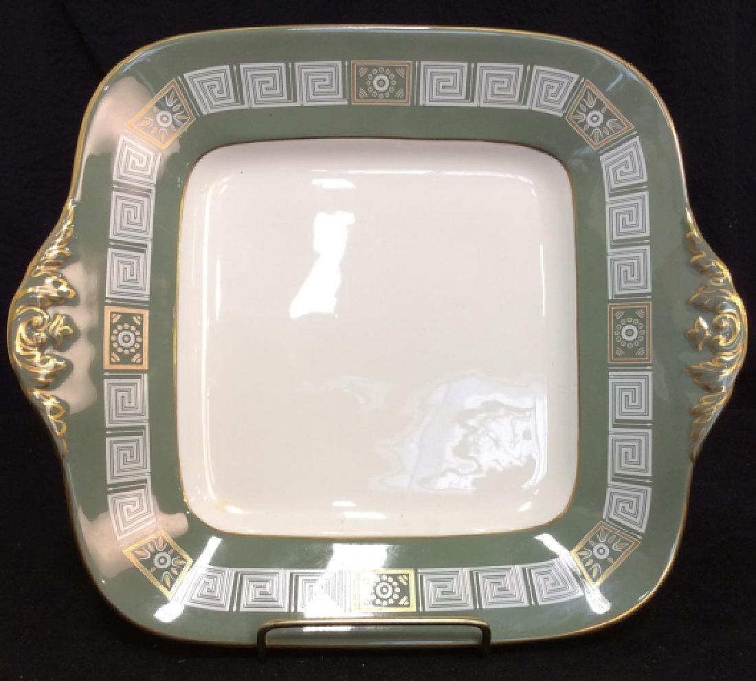 WEDGWOOD Bone China Decorative Plate: WEDGWOOD Bone China Decorative Plate. White toned bone chine, square plate with handles, decorated with green toned trim, geometric design, gold toned metallic filigree and line details. Measures appr