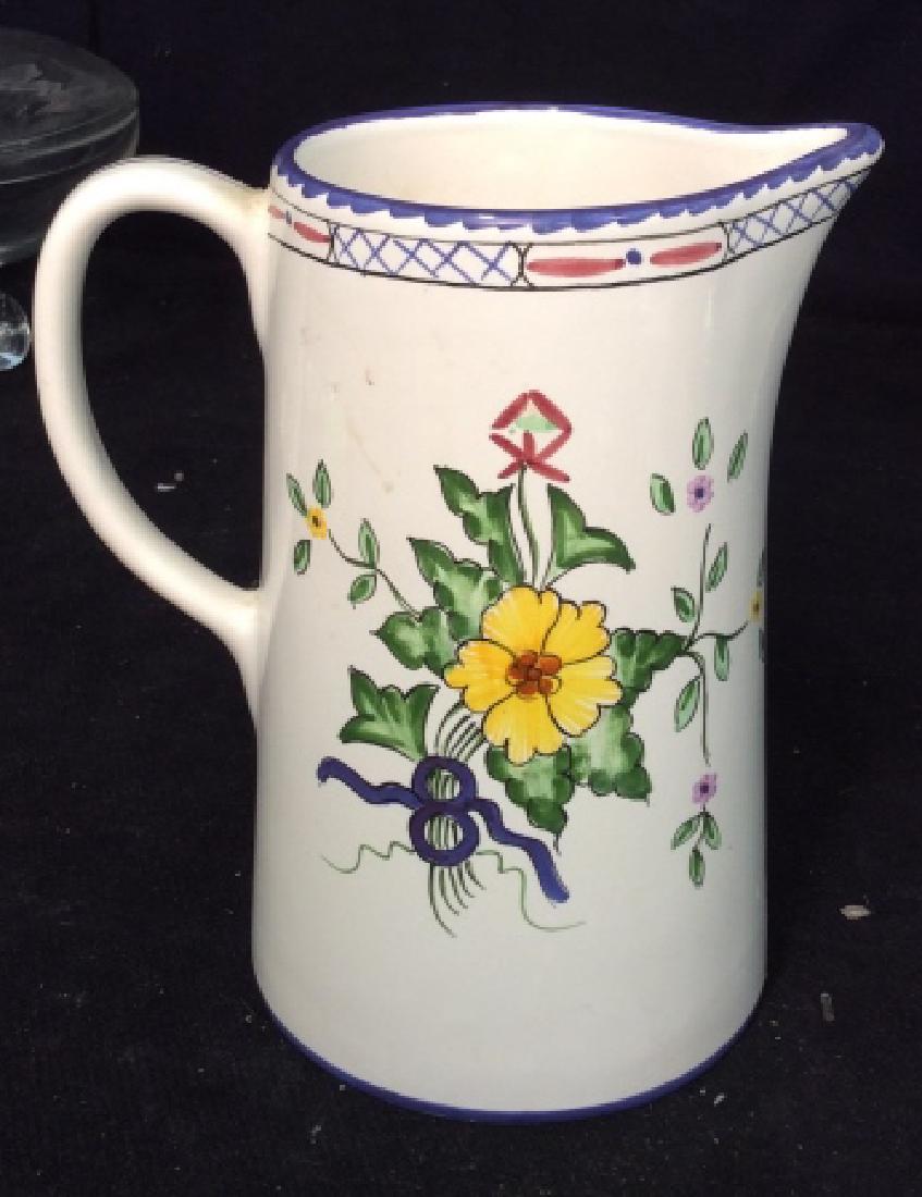 TIFFANY&CO Ceramic Pitcher: Ceramic Pitcher marked on base “ Hand Painted in Portugal for Tiffany & Co”, cream ground covered with blue, red green yellow flower design, good condition, approx 6 1/2 in height, 4 1/4 in diamet