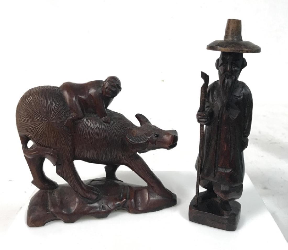 Lot 2 Vintage Asian Carved Pos Cherrywood Figurals: Lot 2 Vintage Asian Carved Pos Cherrywood Figurals. Two hand carved Asian Figurals one depicting a water buffalo with Asian man on its back w black beaded eyes, the other is of a bearded Asian man sta
