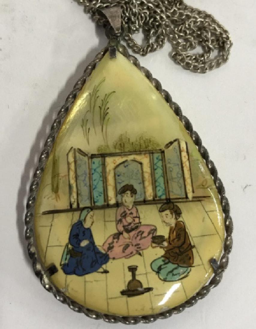 Asian Painted Mother of Pearl Necklace: Hand painted mother of pearl pendant necklace, tear drop form measures app 2.5 by 1.5 inches, silver toned filigree setting and chain, one side hand painted figures in courtyard, second side intricate
