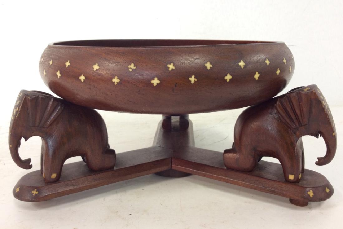 AFZAL STORES Wooden Bowl & Elephant Stand: Bowl and stand are separate. Stand has 3 carved wooden elephant Figurals. Stand and bowl have carved bone inserts. Measures approx 12 inches long 6 inches tall when put together. decorative tabletop a
