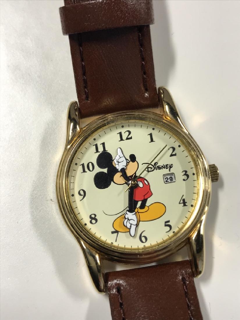 DISNEY BY SII Mickey Mouse Wristwatch: DISNEY BY SII Mickey Mouse Wristwatch Stamped brown toned genuine leather wrist band, gold toned metal casing, iconic Mickey Mouse character on watch face, arms of character act as clock hands. Has no